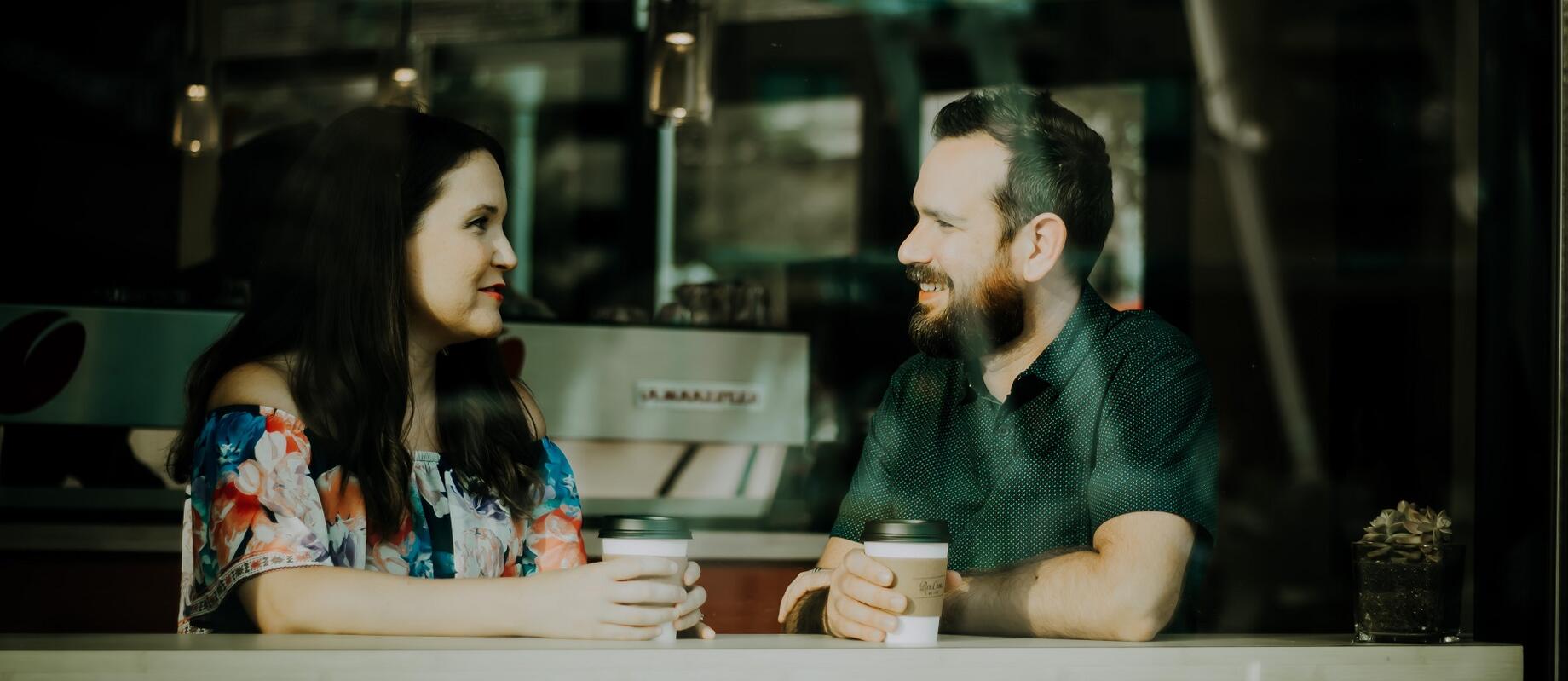 Two people talking in a coffee shop